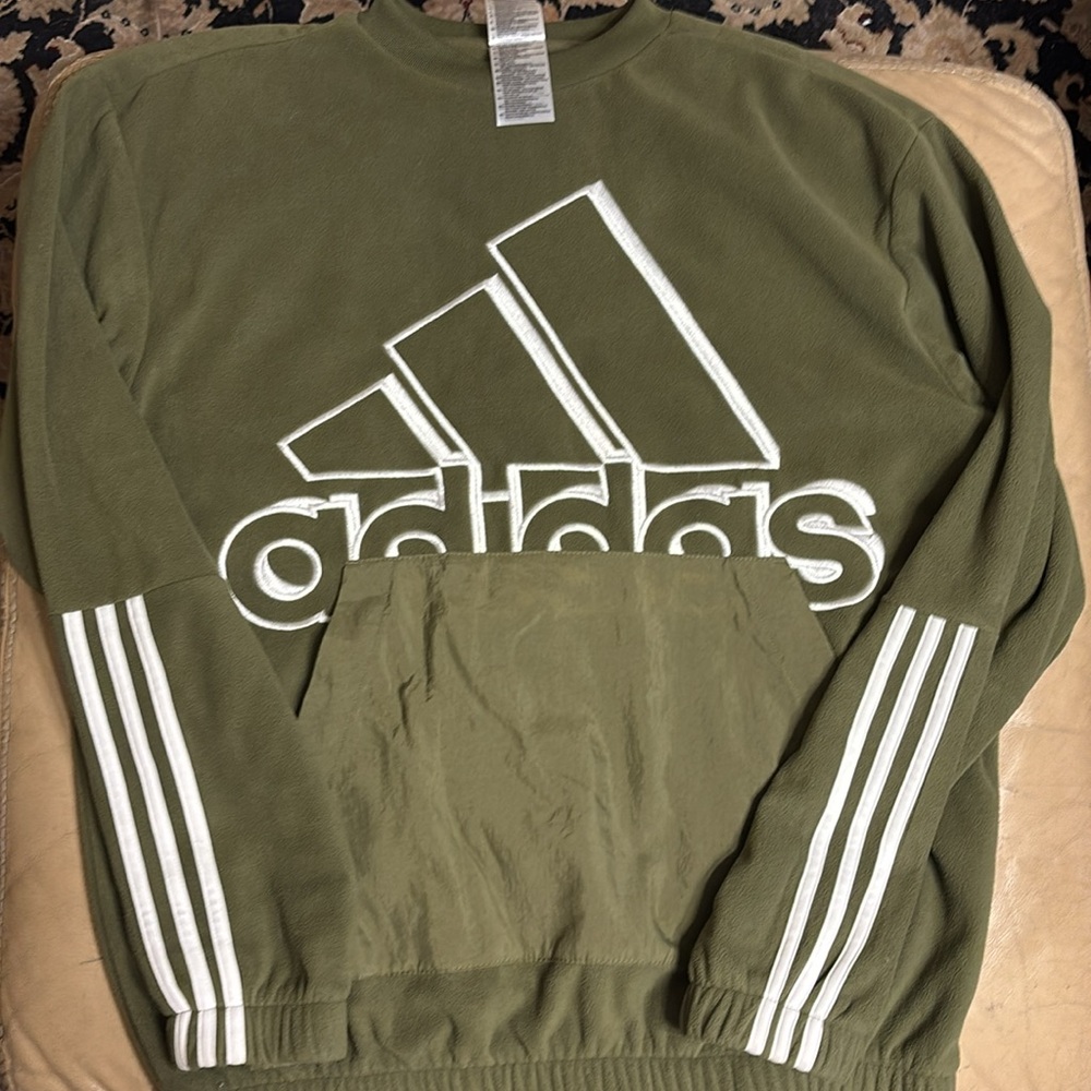 Adidas green sweater with a hoodie pocket.